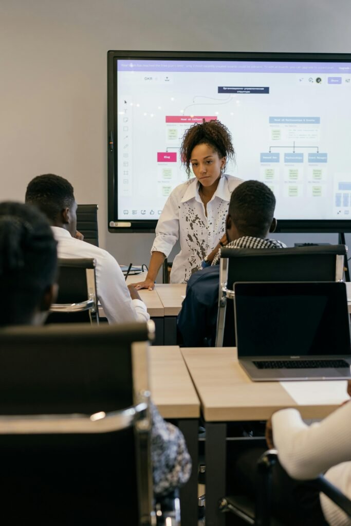 Professionals engaged in a meeting with a digital presentation in a conference room.